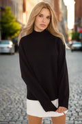 A woman wearing a black half turtleneck sweater with long sleeves, paired with a white skirt.