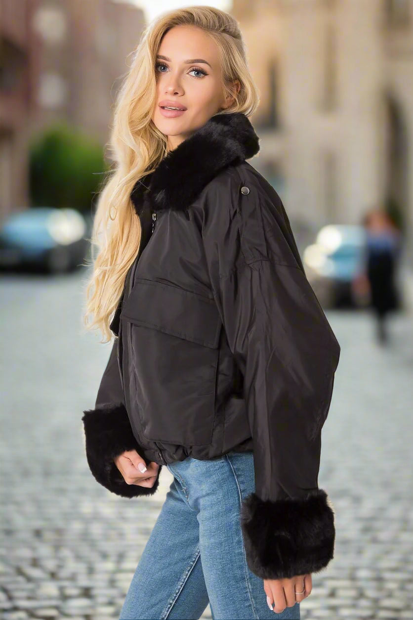 Stay stylish and warm this season with our elegant black women's jacket, designed to combine luxury and functionality. Featuring a removable fur trim at the collar and sleeves, this versatile jacket offers a touch of sophistication while keeping