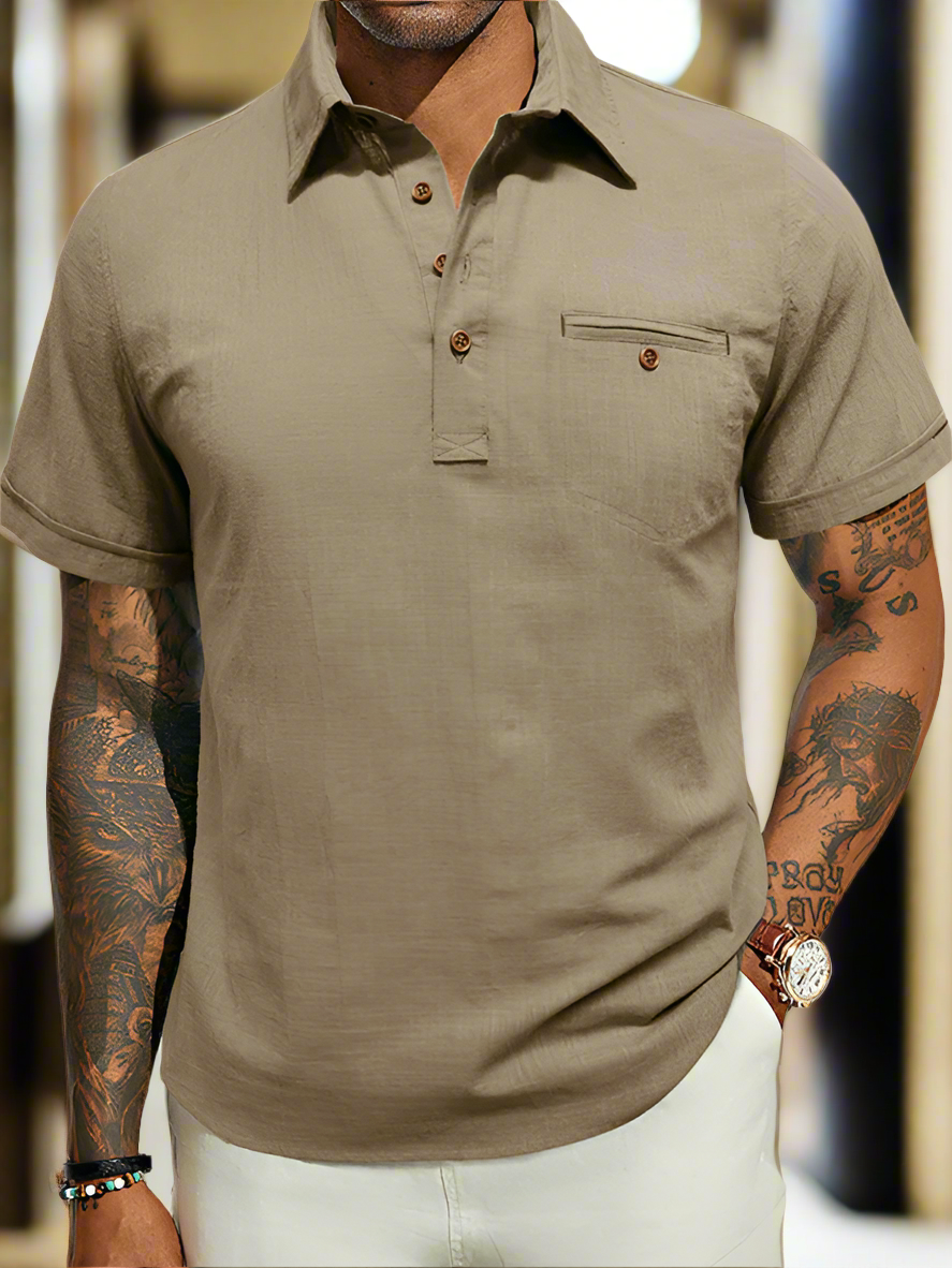 A male model wearing a brown, short-sleeved, casual-style lapel top with a collar.